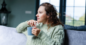 Woman holding coffee mug.